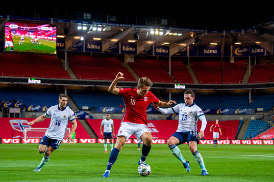 Sander Berge of Norway and Corry Evans of Northern Ireland