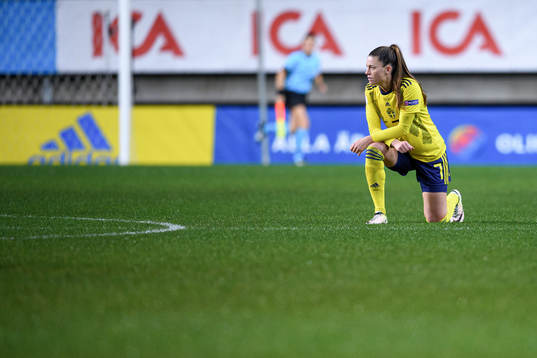 Pauline Hammarlund of Sweden kneels in support of the