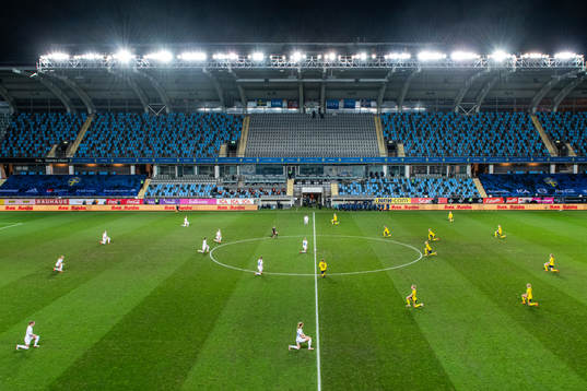 Players of Sweden and Iceland kneel in support of the