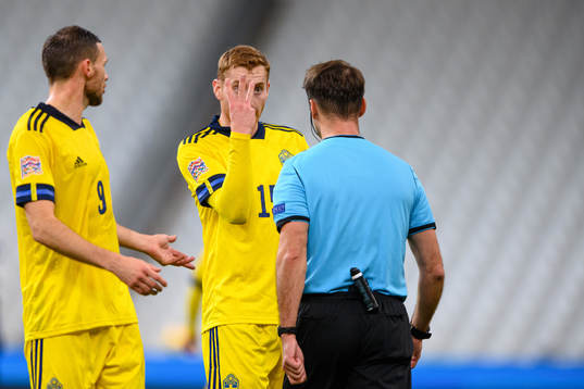 Dejan Kulusevski of Sweden and referee Aleksei Kulbakov