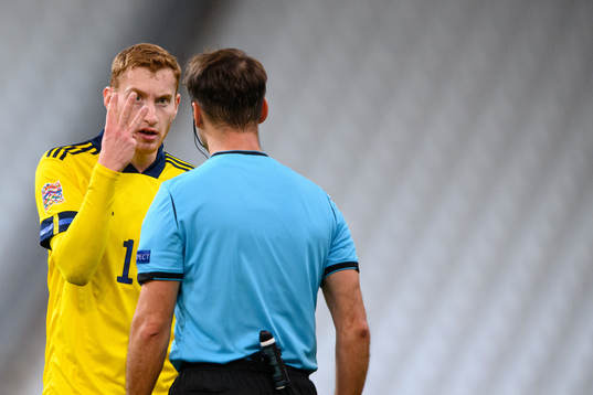 Dejan Kulusevski of Sweden and referee Aleksei Kulbakov