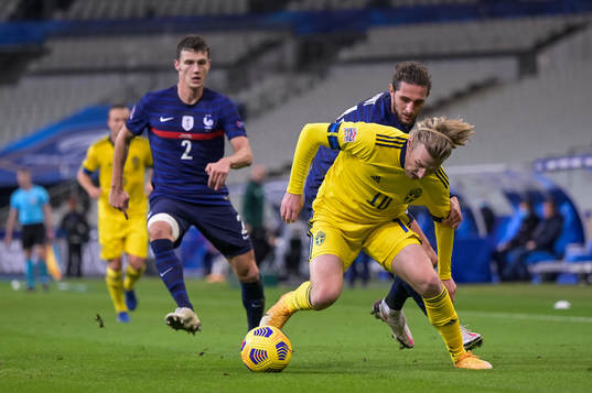 Benjamin Pavard and Adrien Rabiot of France against Emil