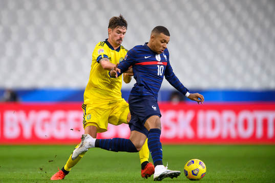 Mikael Lustig of Sweden and Kylian Mbappé of France