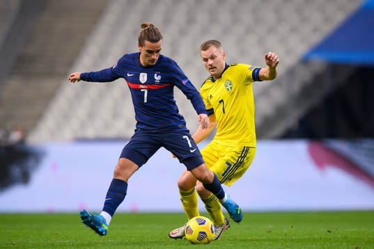 Antoine Griezmann of France and Sebastian Larsson of Sweden
