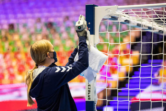 A steward steams the goalpost to disinfect it
