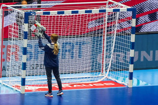 A steward steams the goalpost to disinfect it