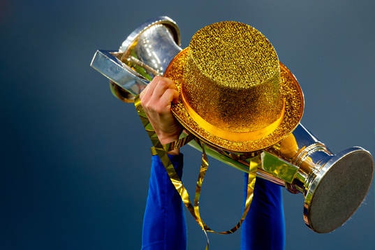The league trophy is being lifted by a player of Vålerenga