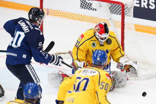 Niko Ojamaki of Finland and goalkeeper Anders Lindbäck of