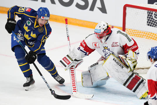 Lawrence Pilut of Sweden and goalkeeper Simon Hrubec of