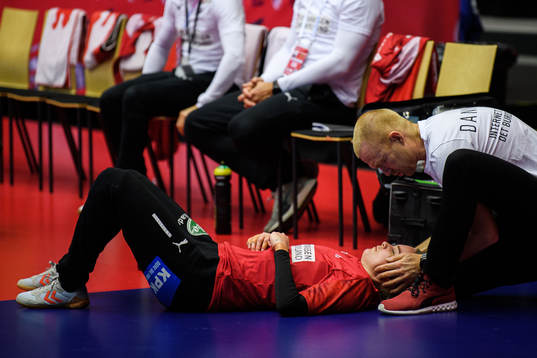 Goalkeeper Sandra Toft of Denmark receives treatment