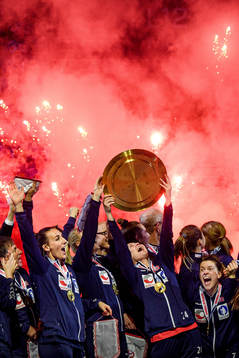 Players of Norway celebrate with the winner’s trophy