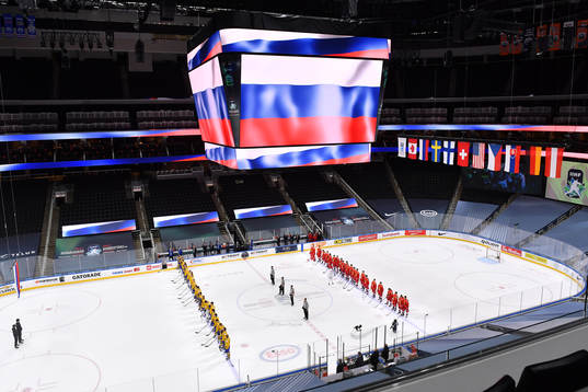 Team Sweden and Team Russia stand for the playing of the