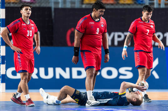 Javier Frelijj of Chile walks over Lukas Sandell of Sweden