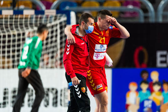 Mario Tankoski of North Macedonia is helped of the pitch