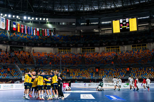 Players of Sweden celebrate while players of of Egypt look
