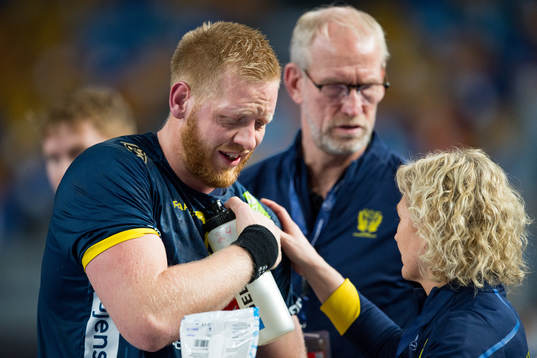 Jim Gottfridsson of Sweden in pain beside physio Johanna