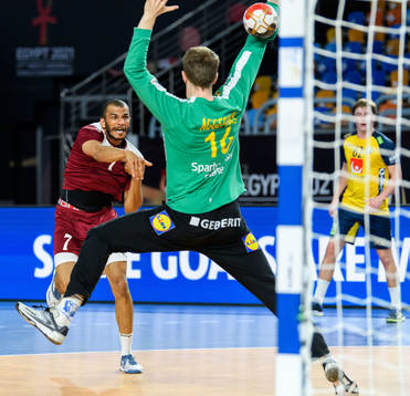 Ahamad Madadi of Qatar and goalkeeper Mikael Aggefors of