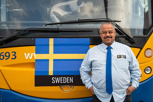 Hicham the bus driver for the Swedish team poses for a