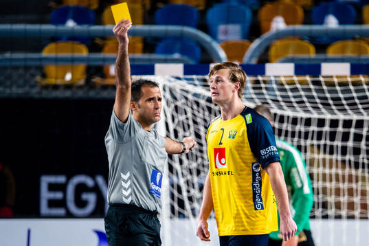 Jonathan Carlsbogård of Sweden gets a yellow card