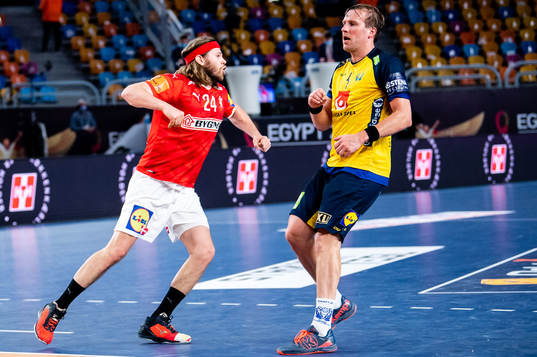 Mikkel Hansen of Denmark celebrates and Max Darj of Sweden