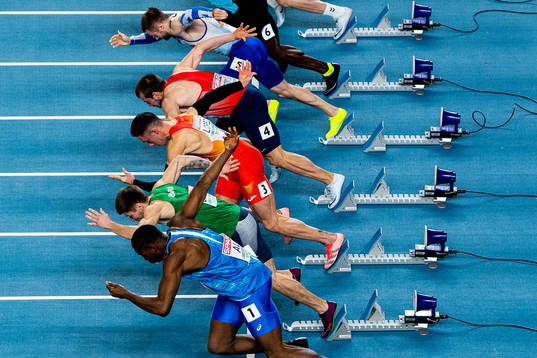 Athletes compete in men's 60 meter qualification