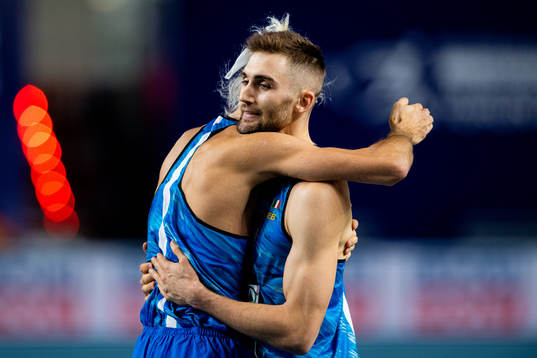 Gianmarco Tamberi and Tobia Bocchi of Italy hug while
