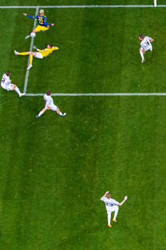 Robin Quaison of Sweden jumps over goalkeeper Matvei Igonen