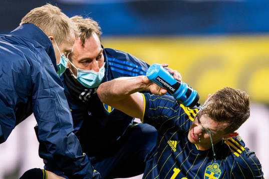 Emil Krafth of Sweden receives medical attention