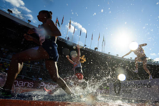 Athletes compete in women's 3000 meter steeplechase