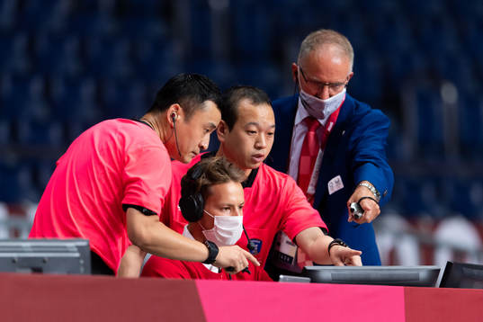 The referees check a goal in the women's handball match