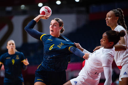 compete in the women's handball match between Sweden and