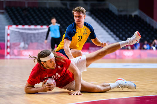 Mikkel Hansen of Denmark and Lucas Pellas of Sweden in the