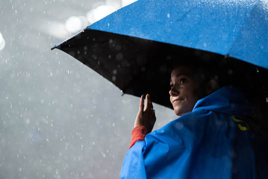 Angelica Bengtsson of Sweden with an umbrella due to heavy