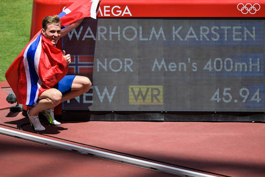 Karsten Warholm of Norway poses in front of the scoreboard