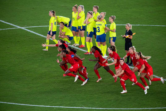 Players of Canada celebrates winning and players of Sweden