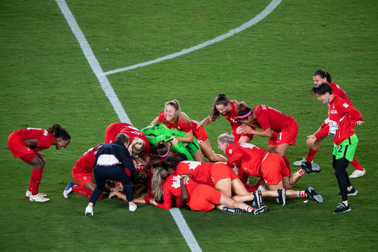 Players of Canada celebrates winning and players of Sweden