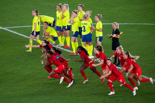 Players of Canada celebrates winning and players of Sweden