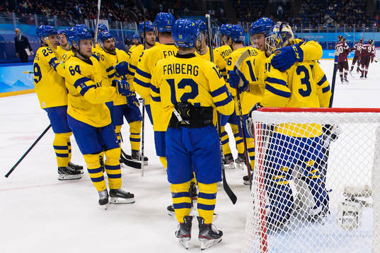 Players of Sweden celebrate their win in an ice hockey