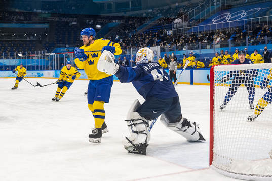 Carl Klingberg of Sweden and goaltender Jussi Olkinoura of