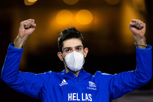 Miltiadis Tentoglou of Greece (gold) celebrate