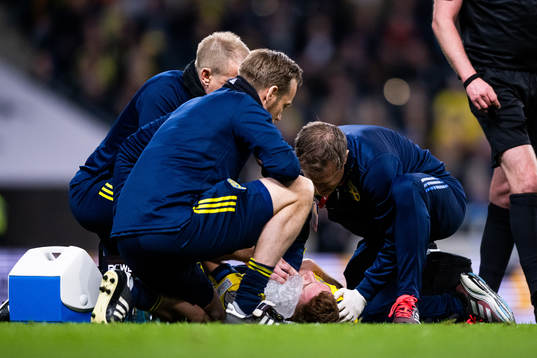 Dejan Kulusevski of Sweden receives medical attention