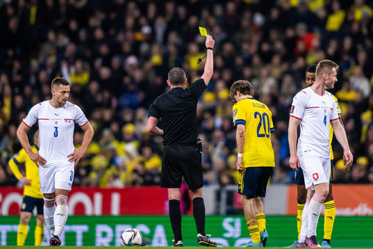 Kristoffer Olsson of Sweden receives a yellow card from