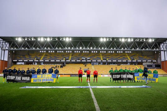 Players of Sweden and Ireland with banners