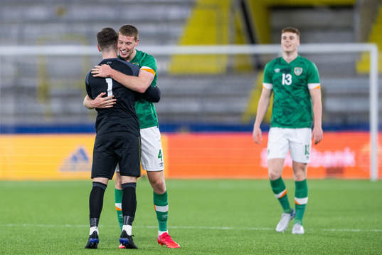 goalkeeper Brian Maher and Mark McGuinness of Ireland
