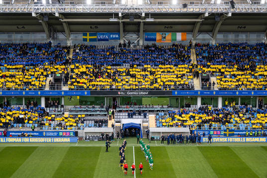 Players of Sweden and of Ireland enter the pitch