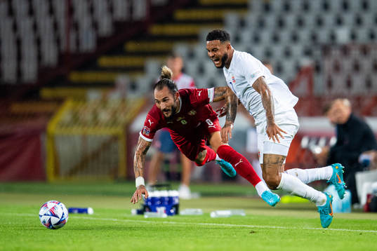 Nemanja Gudelj of Serbia and Joshua King of Norway