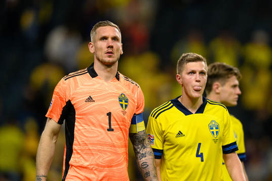Goalkeeper Robin Olsen and Joakim Nilsson of Sweden