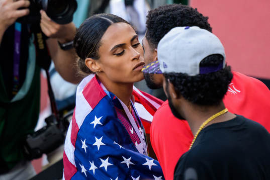 Sydney McLaughlin of USA kisses her boyfriend Andre Levrone