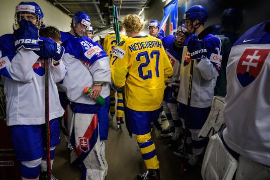 Theodor Niederbach of Sweden walks by Slovakian players to