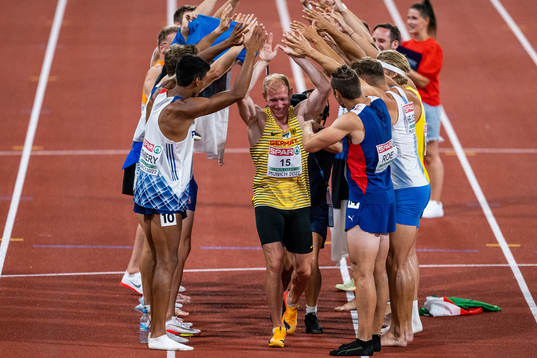 Niklas Kaul of Germany celebrates with competing athletes